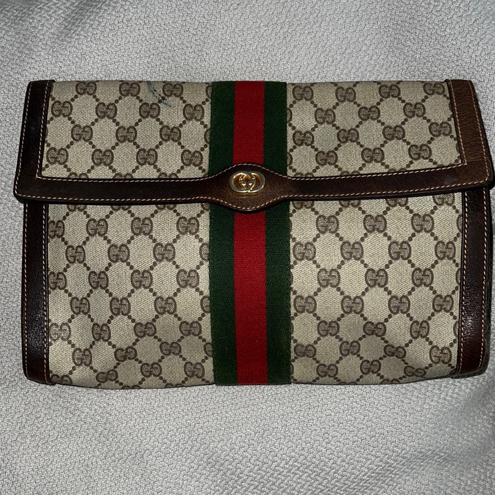 Gucci supreme canvas clutch with button closure